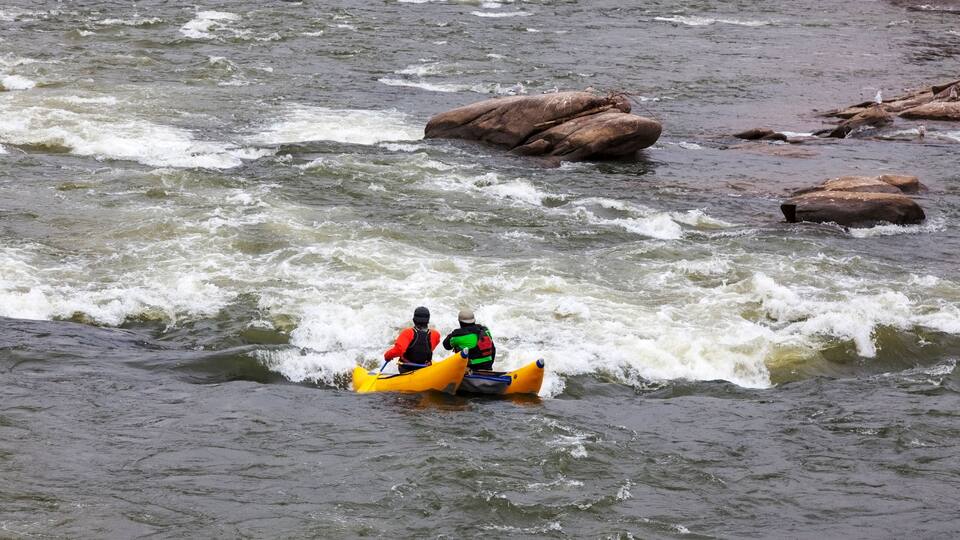 Two rafters approaching rapids on the James River in Richmond, Virginia on a bitter cold winter afternoon.