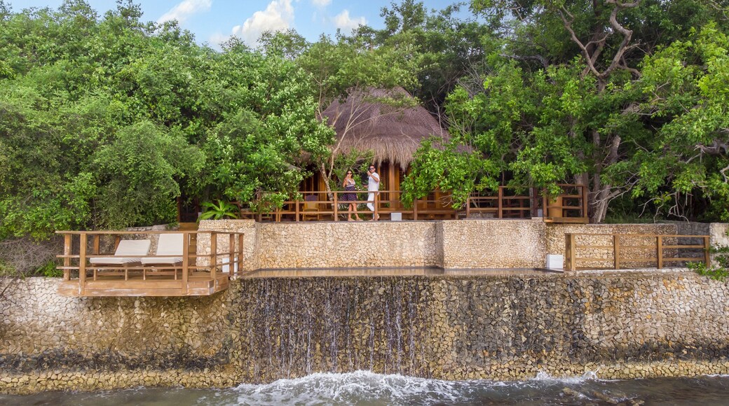 Lovely couple celebrating in a bungalow balcony in the middle if a village in nature.