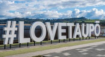 Hashtag Love Taupo sign in front of Lake Taupo in New Zealand.