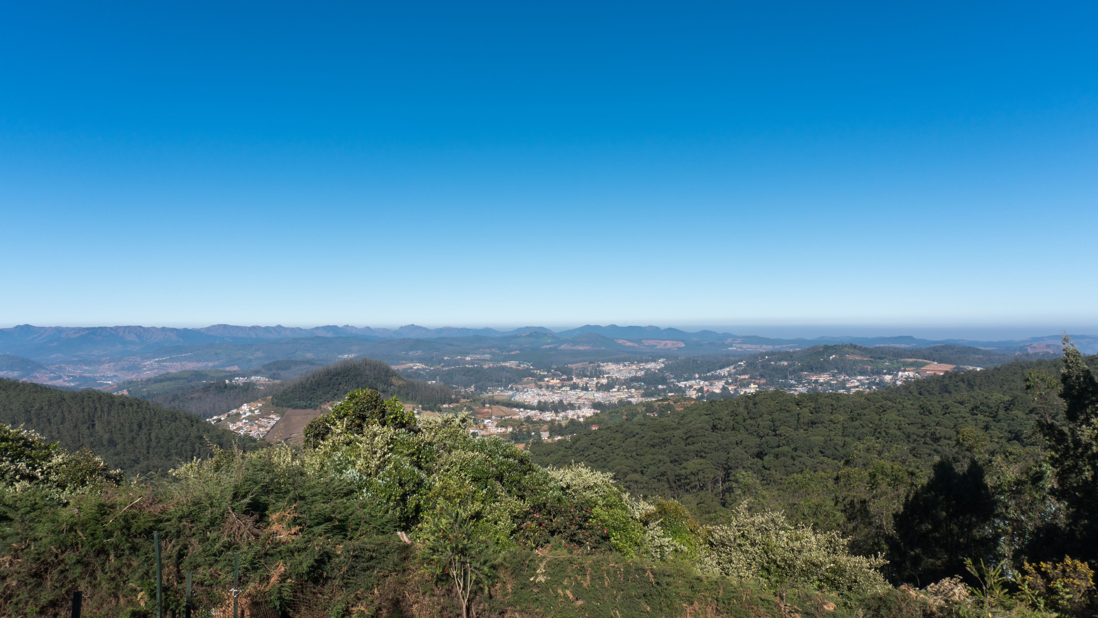 scenic view from Doddabetta peak, highest peak in nilgiri district, forest reserve with the blue sky background. 