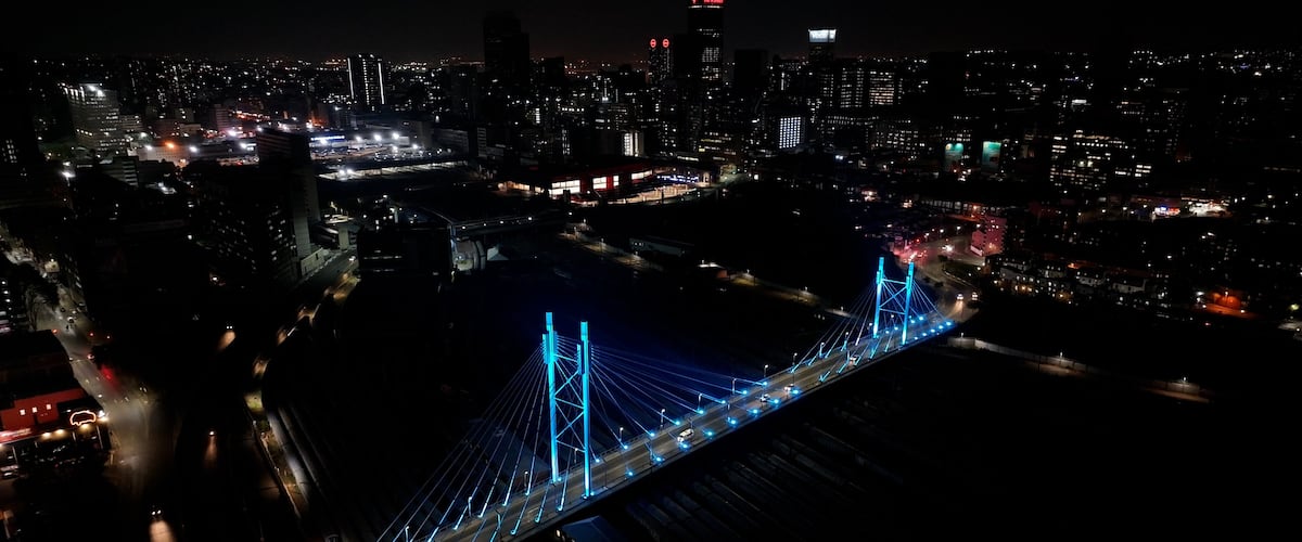 Mandela Bridge At Johannesburg In Gauteng South Africa. Night Scape Town. Illuminated Cable Stayed Bridge. Johannesburg At Gauteng South Africa. Landmark Bridge. Colorful Skyline.