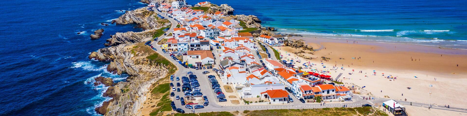 Aerial view of island Baleal naer Peniche on the shore of the ocean in west coast of Portugal. Baleal Portugal with incredible beach and surfers. Aerial view of Baleal, Portugal.