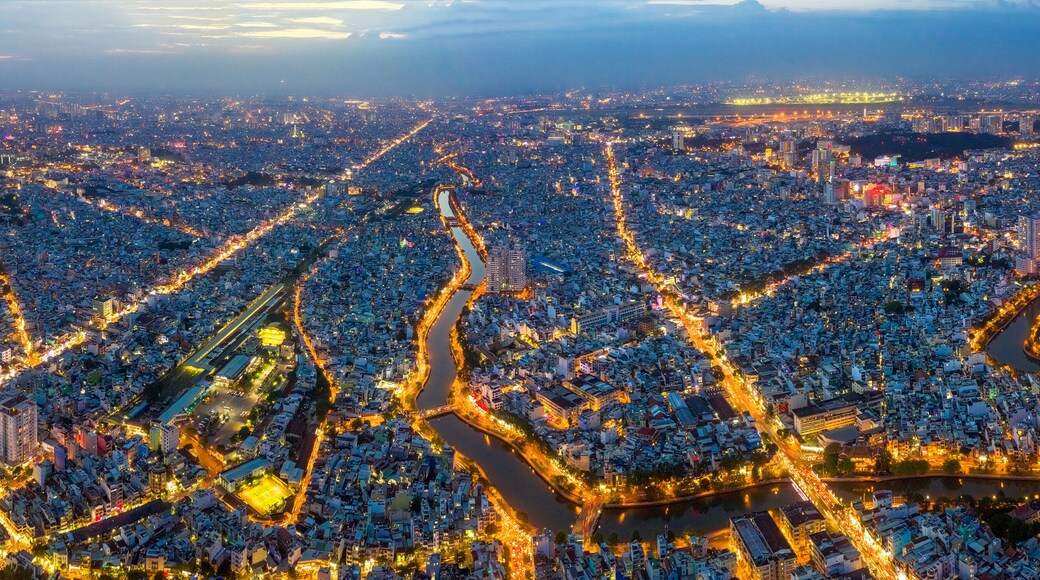 Top view aerial of Ho Chi Minh City, Vietnam with Nhieu Loc - Thi Nghe canal and Tan Son Nhat airport, with development buildings, transportation, energy power infrastructure. View from District 3
