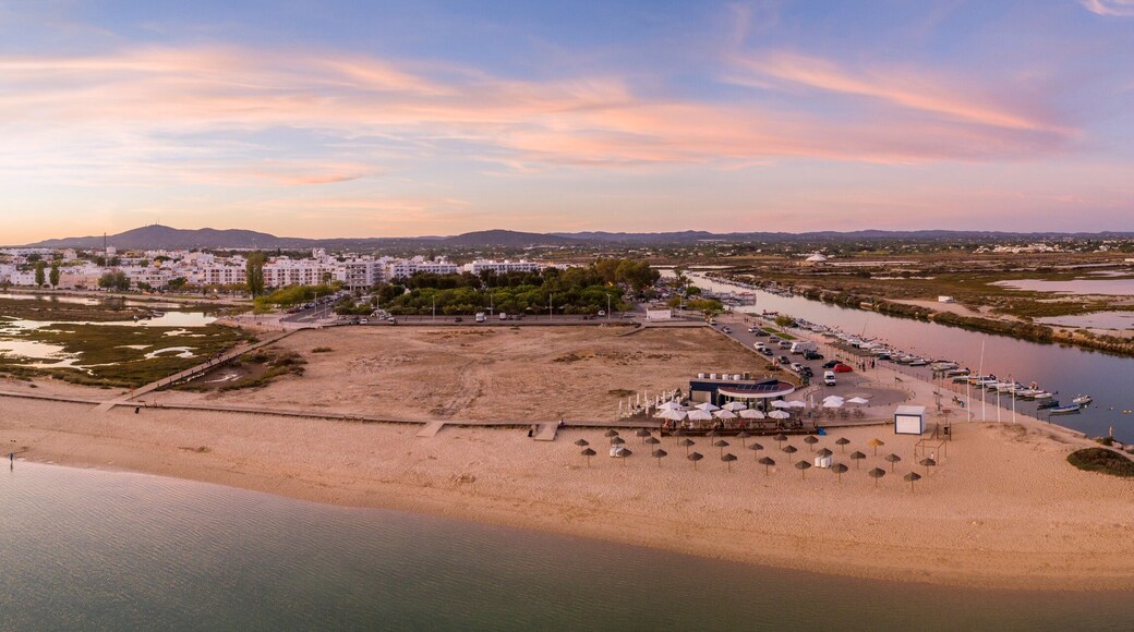 Aerial dusk panoramic view at Fuseta fishing town, in Ria Formosa wetlands nature conservation park, Algarve. Portugal.