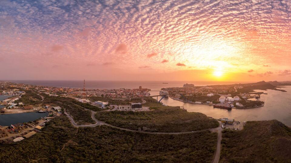 Aerial view of dramatic sunset sky over Willemstad Curacao with orange, red colors