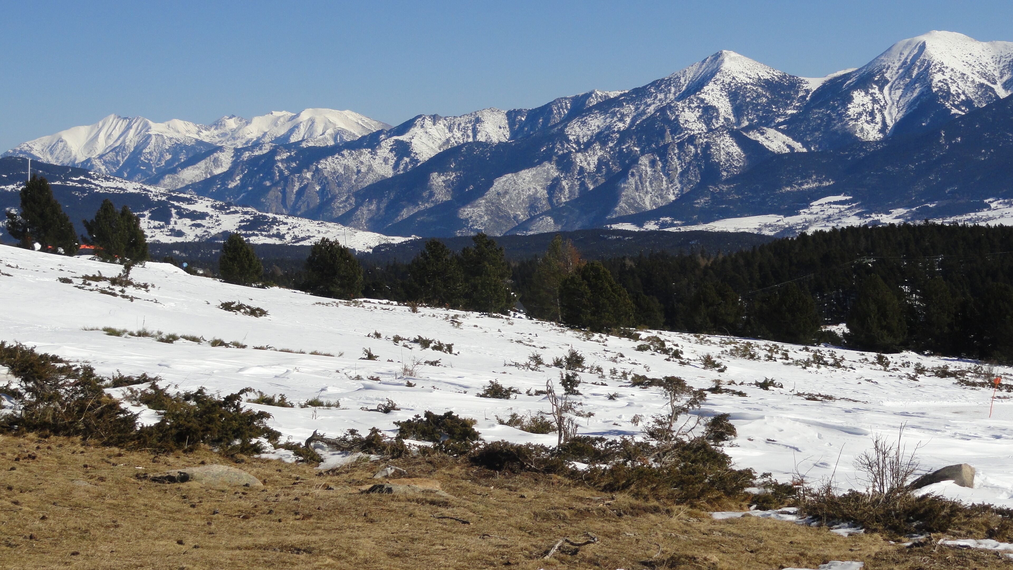 A snow-covered mountain landscape with a clear sky.