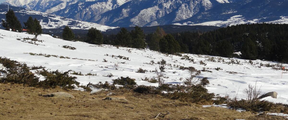 A snow-covered mountain landscape with a clear sky.
