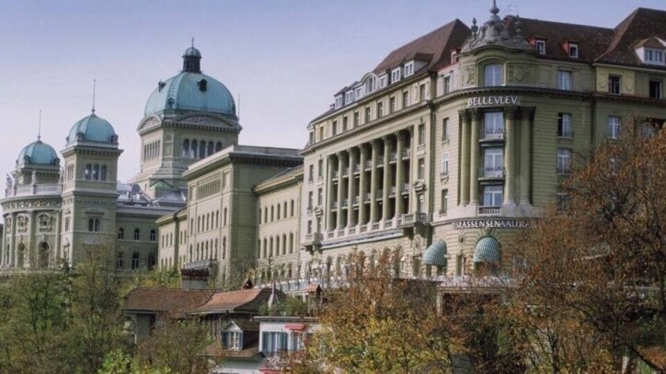 A large, historic building with domed structures and columns.