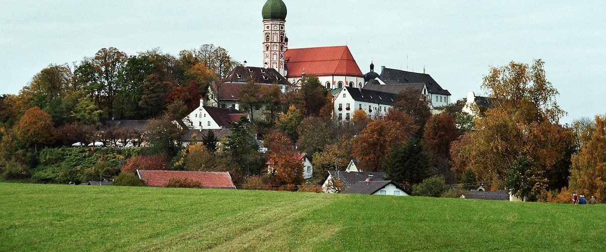 A historic town with a prominent church tower and surrounding houses.