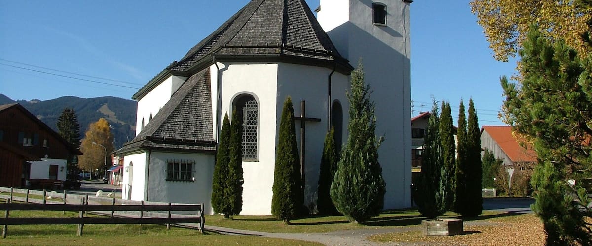 A church with a steeple and a clock tower.