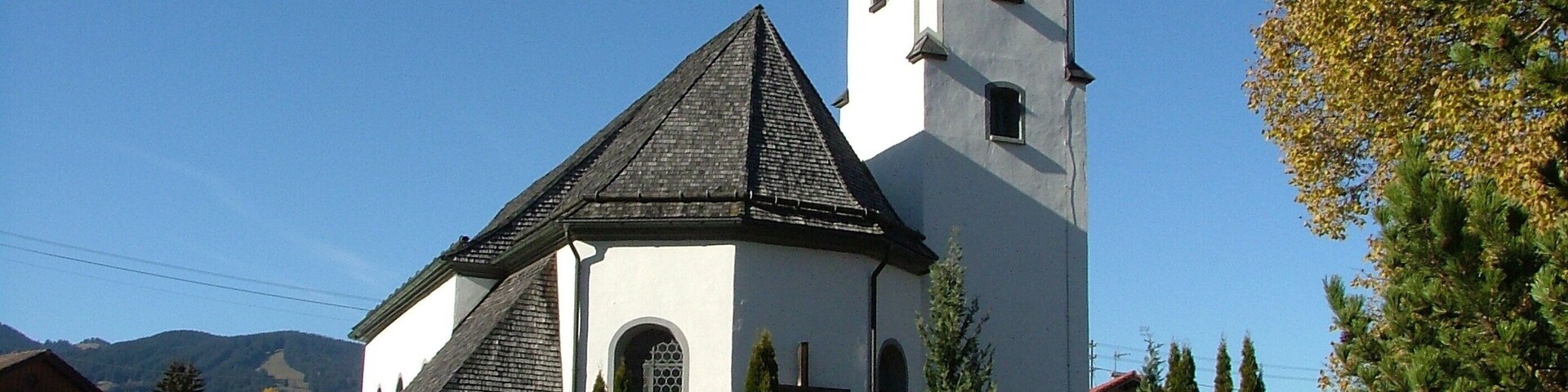 A church with a steeple and a clock tower.