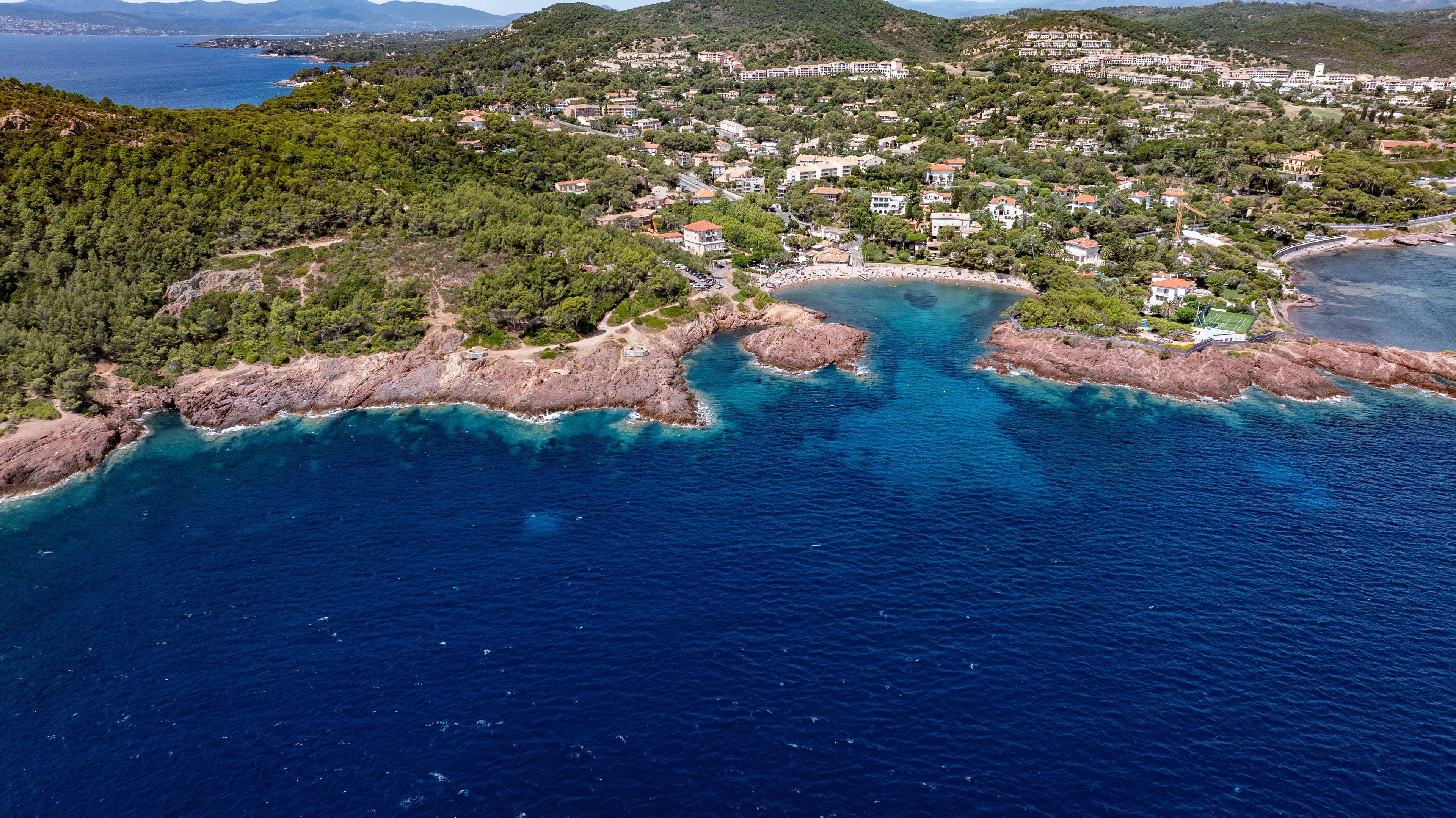 aerial landscape view of coastline along Agay Bay, French Riviera (Côte d'Azur) near Cap Dramont, a nature preserve, Beach "Plage de Camp Long" and Cap Esterel in background, located in Saint-Raphaël