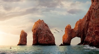 Rocky formations on a sunset background. Famous arches of Los Cabos. Mexico. Baja California Sur. Panoramic image. Banner format.