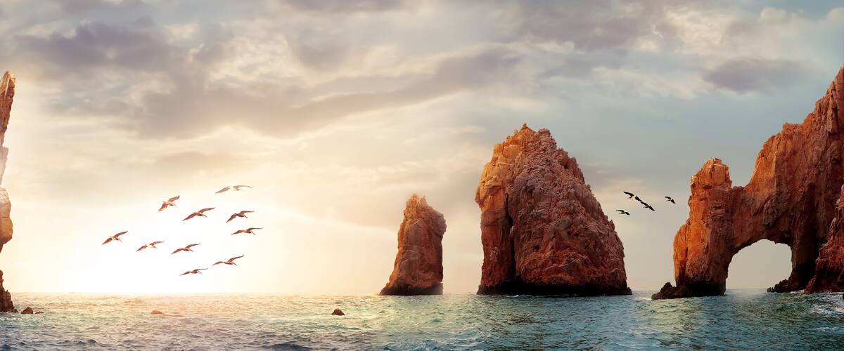 A coastal landscape with tall rock formations and a sea.