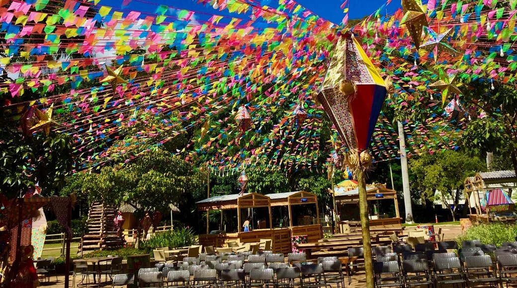 Beautiful coloured flags hanging from strings for a celebration in Brazil. Underneath, rows of chairs are visible. This photo was taken at the Pousada do Rio Quente resort in Goiás, Brazil.