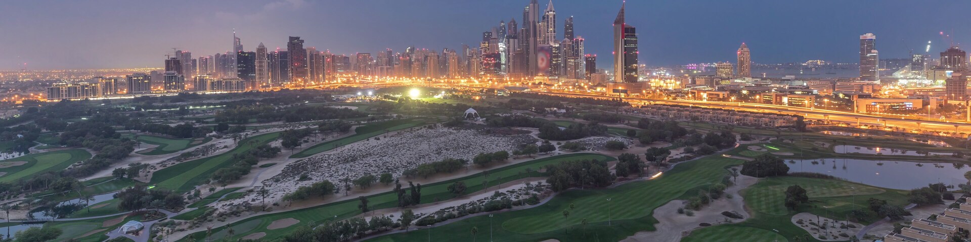Dubai Marina skyscrapers and golf course night to day timelapse, Dubai, United Arab Emirates