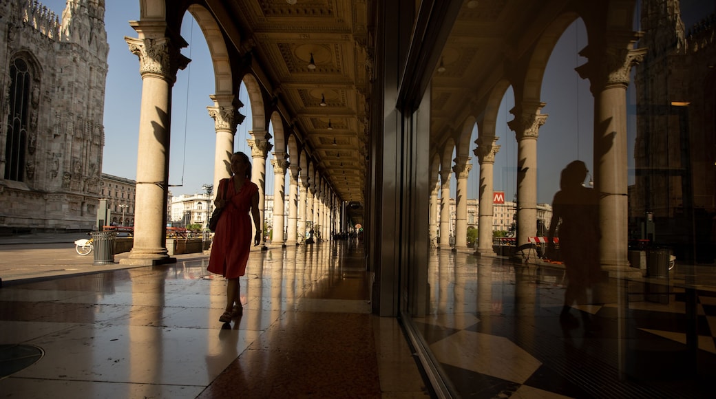 Strolling through the grand colonnade of Duomo Cathedral in Milan under the warm evening light