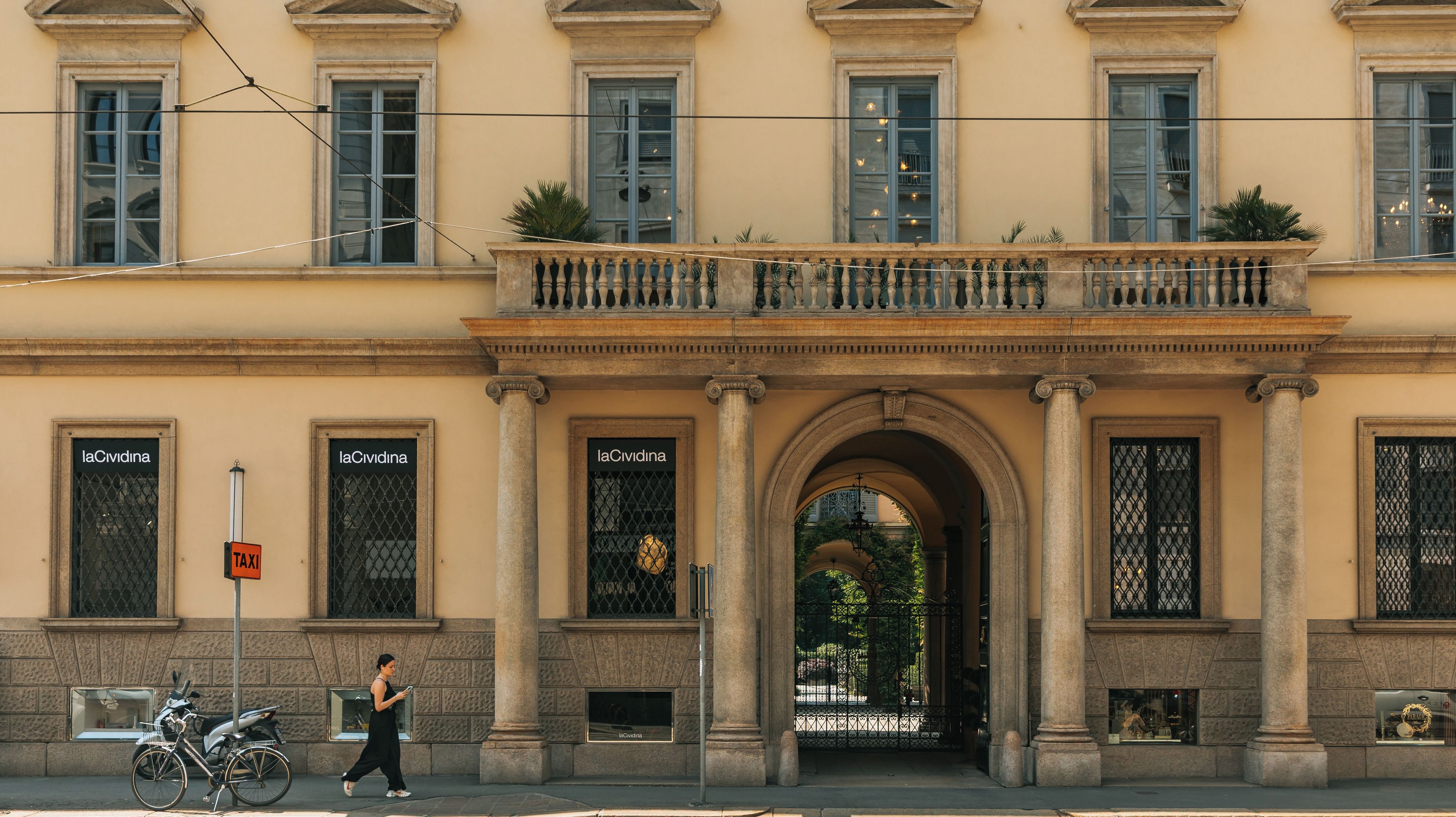 A historic building with columns, a balcony, and a sign reading 'laCividina'.