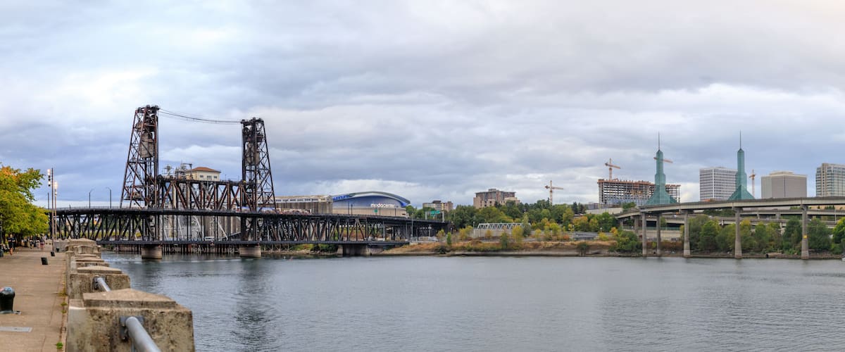 Steel bridge over Willamette river with Portland skyline