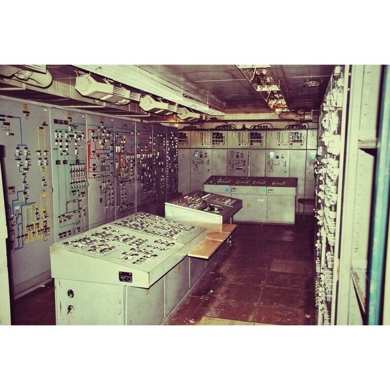 A control room with multiple control panels and switches.
