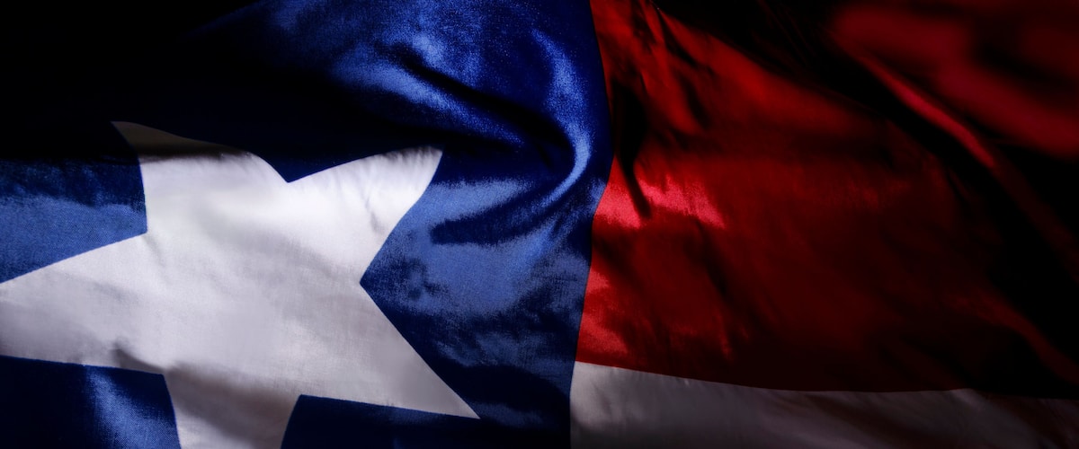 The Texas state flag waving in shadow