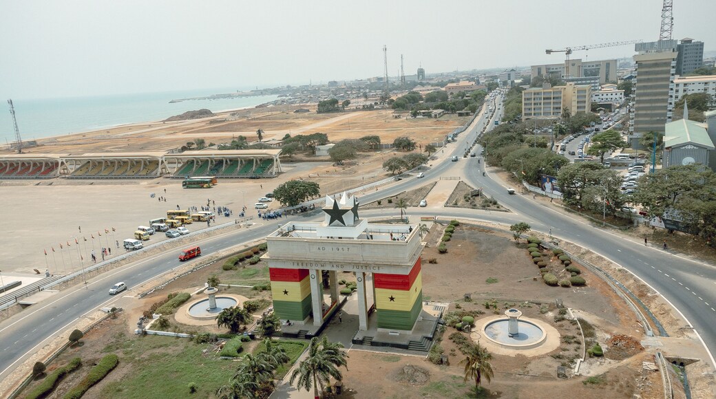 Aerial view of the iconic Black Star Gate arching proudly against the skyline with roads bustling with cars, Osu Klottey, Greater Accra Region, Ghana.