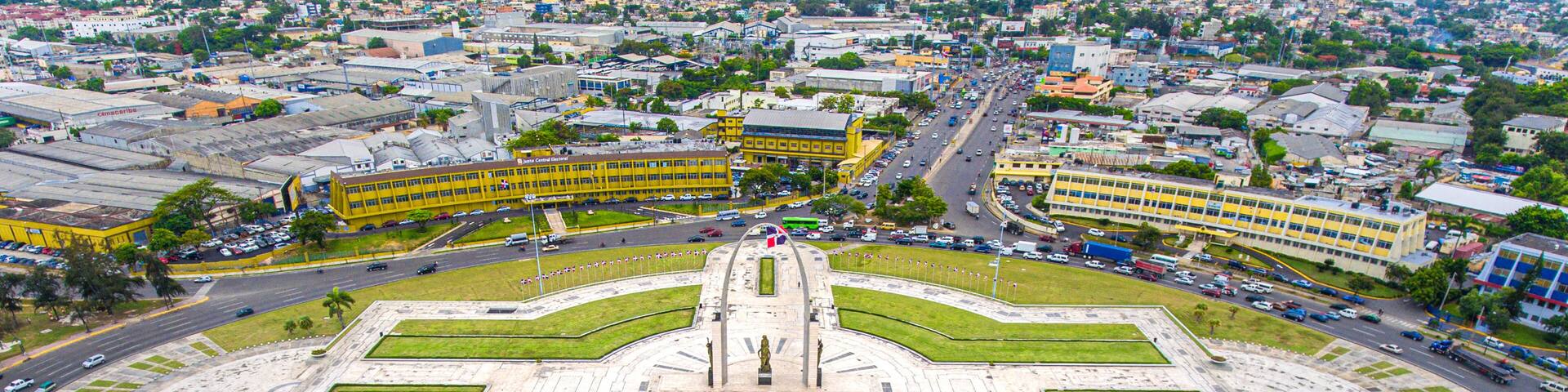 A large circular plaza with a central monument, surrounded by roads and buildings.