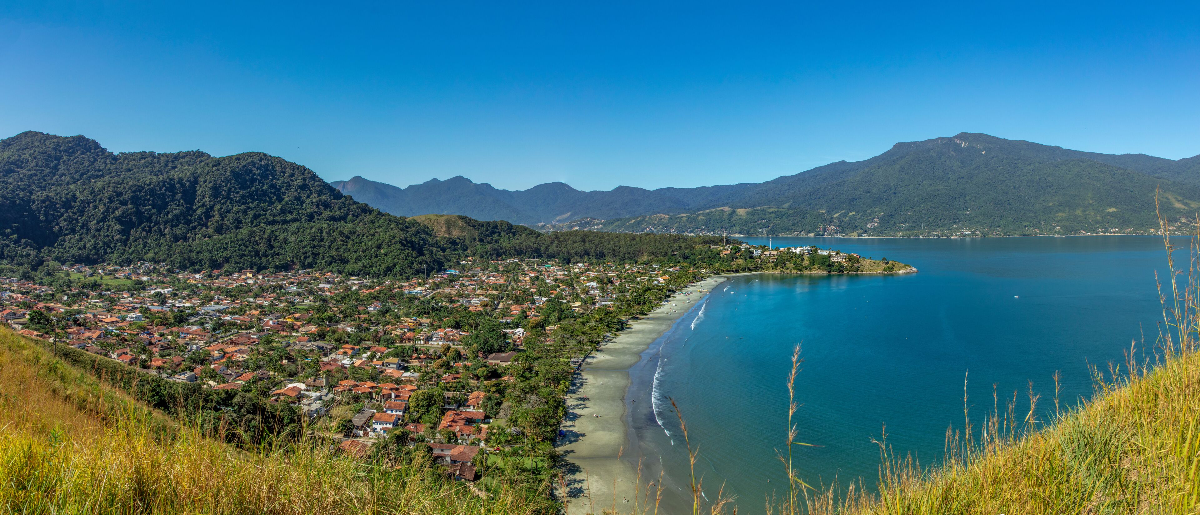 Beautiful panoramic view of Ilhabela island and coast of Sao Sebastiao, tropical island on the Brazilian sea coast during a sunny day of vacation and sightseeing.