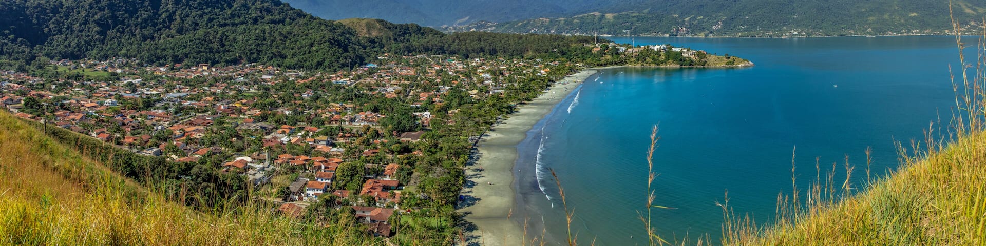 Beautiful panoramic view of Ilhabela island and coast of Sao Sebastiao, tropical island on the Brazilian sea coast during a sunny day of vacation and sightseeing.