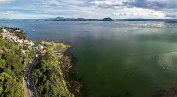 Panorama of Taal volcano and caldera, the coastline of the lake, the town of Laurel, and the Tagaytay mountain ridge.