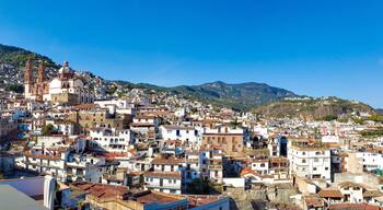 Mexico, Scenic panoramic view of Taxco historic center with colonial houses on the hills and famous Church of Santa Prisca de Taxco