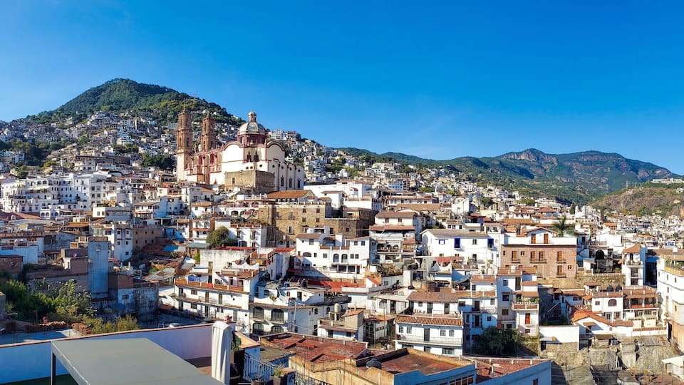 Mexico, Scenic panoramic view of Taxco historic center with colonial houses on the hills and famous Church of Santa Prisca de Taxco