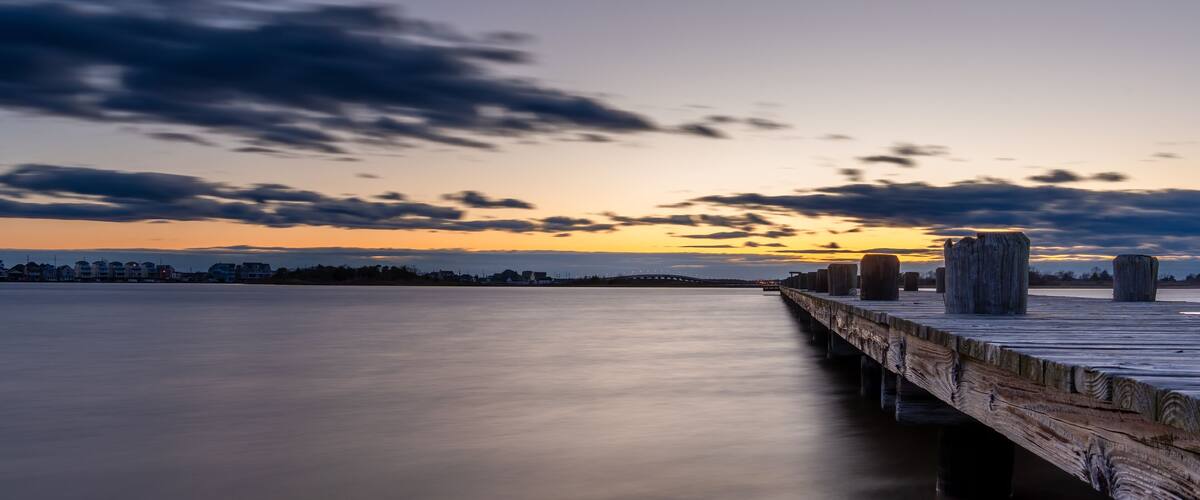 The sky is a beautiful shade of blue with a few clouds scattered throughout on the Barnegat Bay in New Jersey.