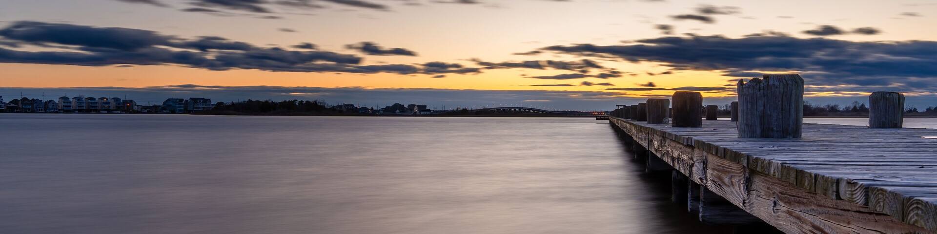 The sky is a beautiful shade of blue with a few clouds scattered throughout on the Barnegat Bay in New Jersey.