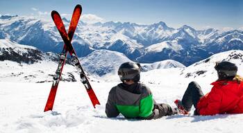 Young happy couple lying in snowy mountains