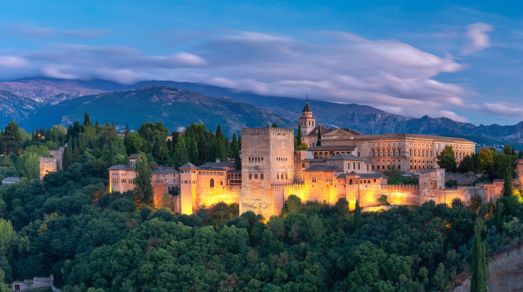 Palace and fortress complex Alhambra with Comares Tower, Palacios Nazaries and Palace of Charles V during sunset in Granada, Andalusia, Spain