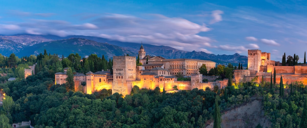 Palace and fortress complex Alhambra with Comares Tower, Palacios Nazaries and Palace of Charles V during sunset in Granada, Andalusia, Spain