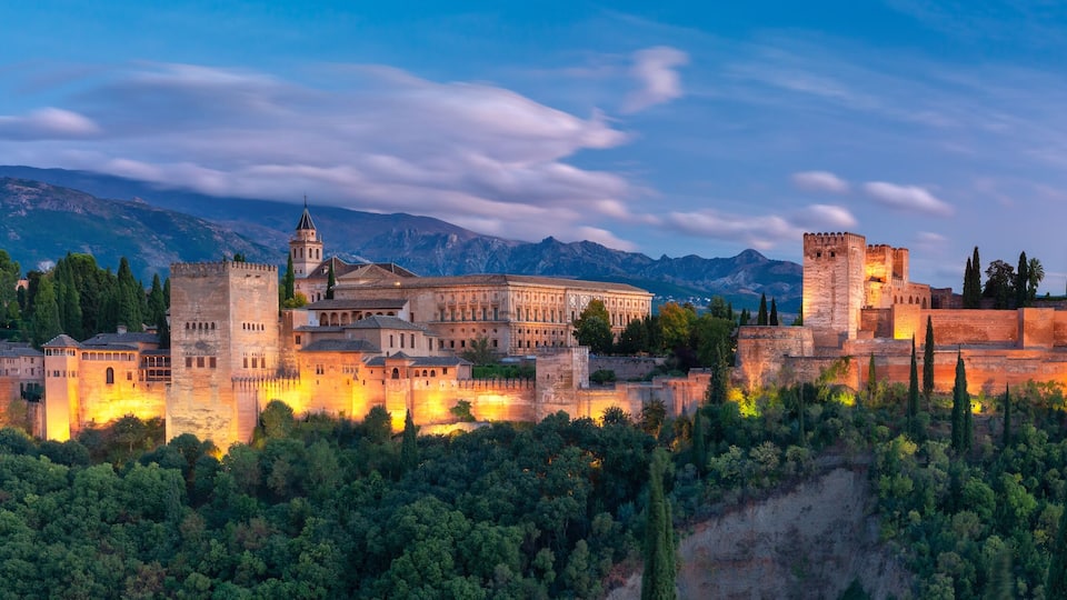 Palace and fortress complex Alhambra with Comares Tower, Palacios Nazaries and Palace of Charles V during sunset in Granada, Andalusia, Spain