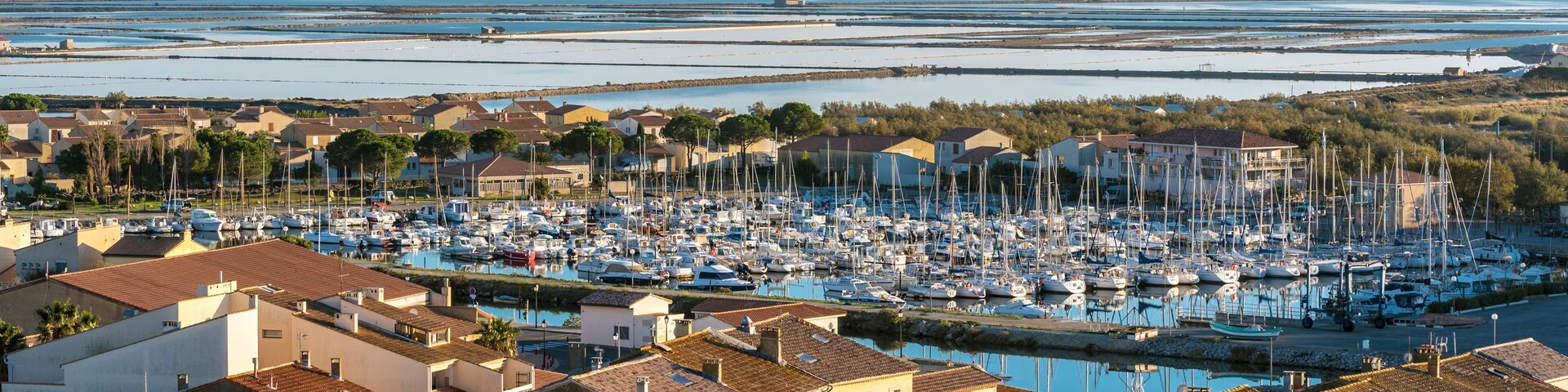 Marina of Gruissan town, Grazel Pond ant Mediterranean coastline as seen from Barberousse Tower. Occitanie, France.