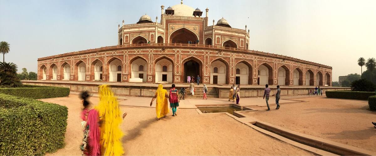 A large, historic building with a central dome and arched windows.