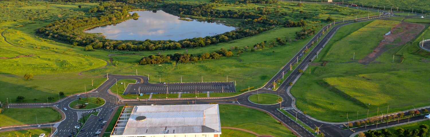 Imagem aérea da cidade de Paulínia (Paulinia SP) durante a hora dourada no final da tarde. Carros, condomínios e vegetação na pequena cidade do interior.