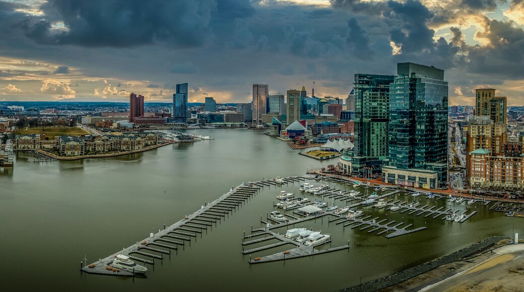Aerial view of stormy sky over the Inner Harbor of Baltimore Maryland with sky scrapers and sailboats