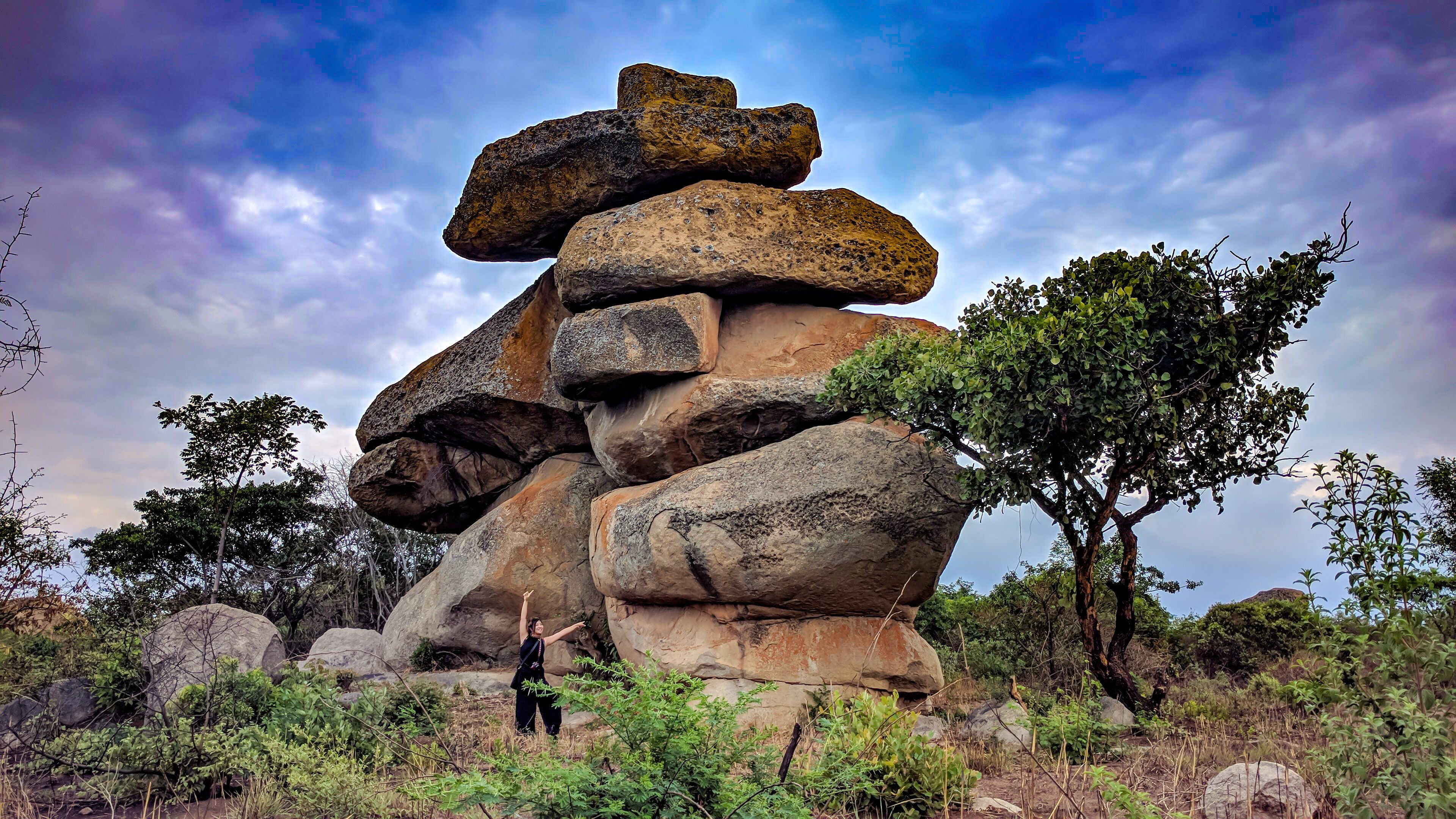 A balancing rock with a woman, Epworth, Harare, Zimbabwe