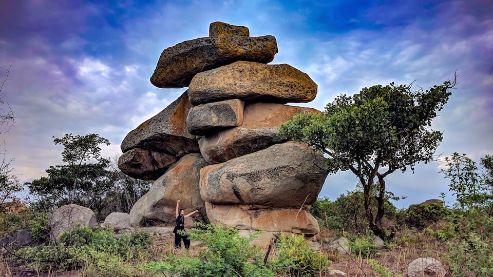 A balancing rock with a woman, Epworth, Harare, Zimbabwe