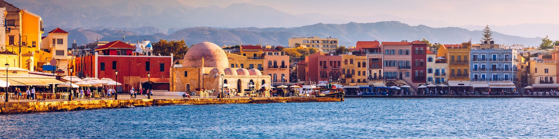 Mosque in the old Venetian harbor of Chania town on Crete island, Greece. Old mosque in Chania. Janissaries or Kioutsouk Hassan Mosque in Chania Crete. Turkish mosque in Chania bay. Crete, Greece.