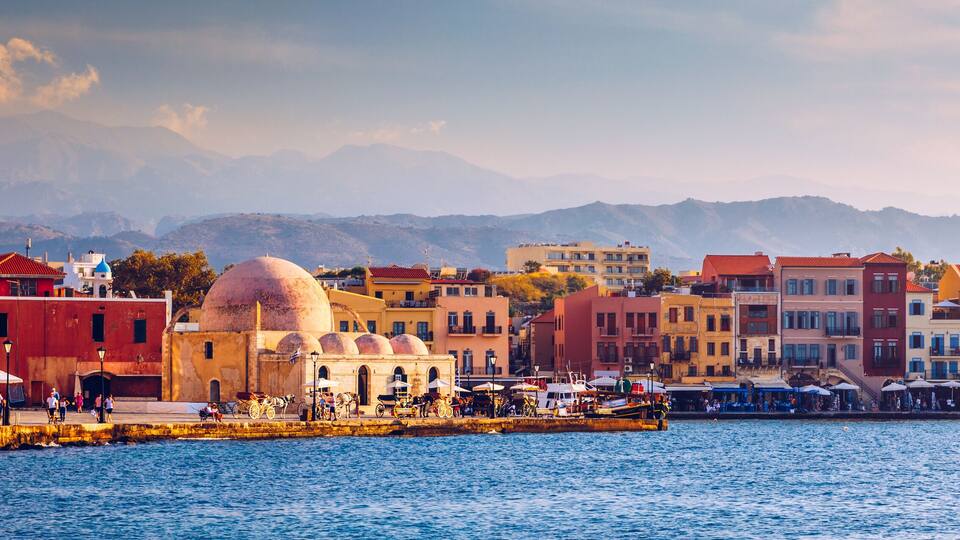 Mosque in the old Venetian harbor of Chania town on Crete island, Greece. Old mosque in Chania. Janissaries or Kioutsouk Hassan Mosque in Chania Crete. Turkish mosque in Chania bay. Crete, Greece.
