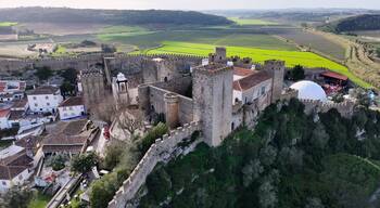 Obidos Castle In Obidos Leiria Portugal. Aerial View Of Landmark Medieval Building In Downtown Scene. Business Clouds Sky Downtown Cityscape. Backgrounds Panoramic. Obidos Leiria.