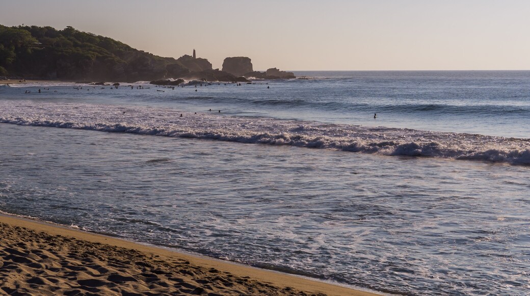 Panoramic view of surfers in la Punta - Playa Zicatela in Puerto Escondido, Mexico