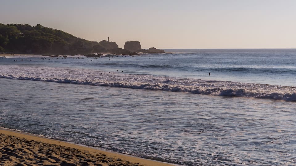 Panoramic view of surfers in la Punta - Playa Zicatela in Puerto Escondido, Mexico