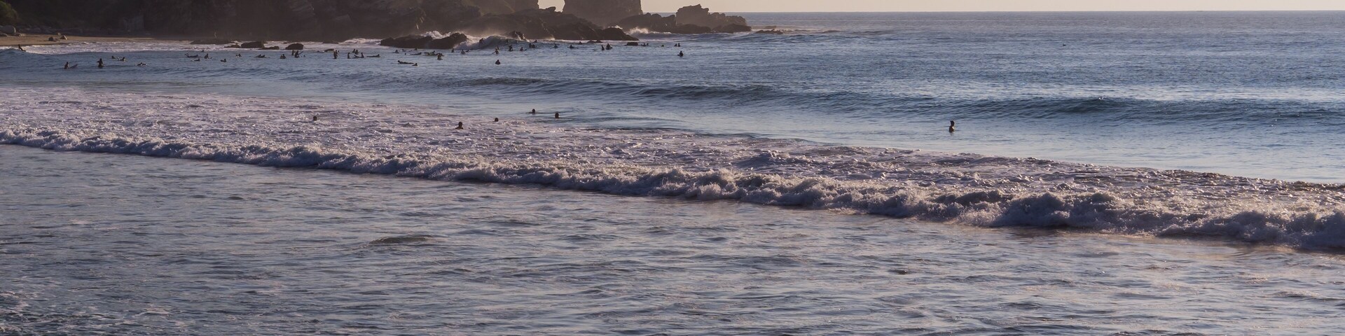 Panoramic view of surfers in la Punta - Playa Zicatela in Puerto Escondido, Mexico